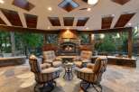 Experience ultimate outdoor living with this stunning covered patio, featuring a grand stone fireplace perfect for cozy evenings.
