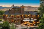Experience luxury living in this stunning multi-level home, featuring a sprawling outdoor entertainment area with a built-in grill and pizza oven.