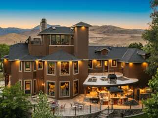 Experience luxury living in this stunning multi-level home, featuring a sprawling outdoor entertainment area with a built-in grill and pizza oven.