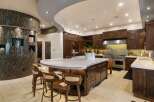 Experience luxury in this stunning gourmet kitchen, featuring a large marble-topped island perfect for entertaining.