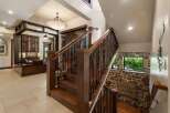 Experience luxury living with this stunning staircase, featuring rich wooden treads and intricate metal balusters that add a touch of rustic elegance.