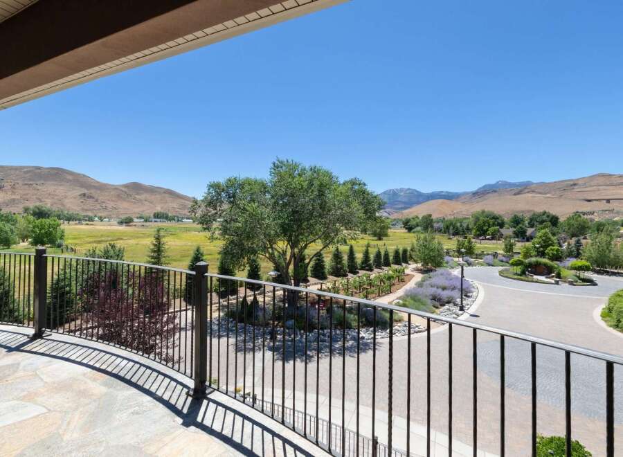 Experience breathtaking panoramic views from this stunning property, featuring a beautifully landscaped yard with mature trees and vibrant lavender gardens.
