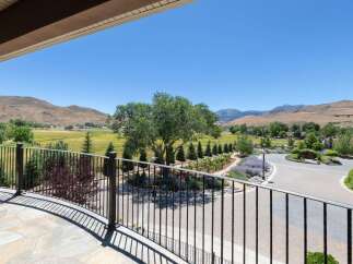 Experience breathtaking panoramic views from this stunning property, featuring a beautifully landscaped yard with mature trees and vibrant lavender gardens.
