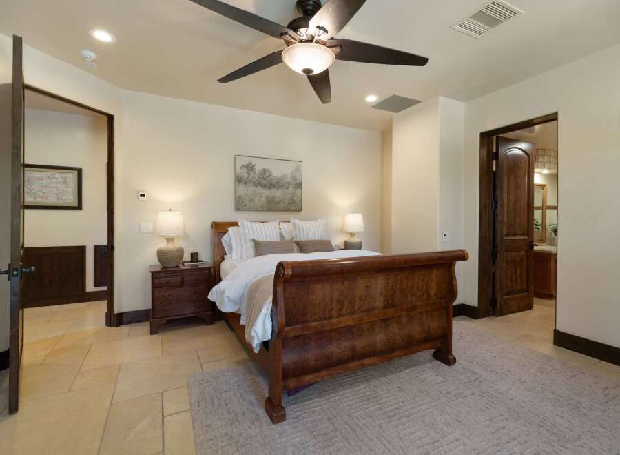 Experience rustic elegance in this charming bedroom featuring a grand wooden sleigh bed as the centerpiece.