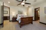 Experience rustic elegance in this charming bedroom featuring a grand wooden sleigh bed as the centerpiece.