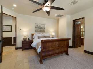 Experience rustic elegance in this charming bedroom featuring a grand wooden sleigh bed as the centerpiece.