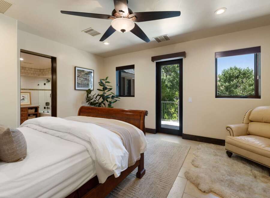 Experience luxurious living in this master suite, featuring a plush king-sized bed and direct access to a private balcony with stunning views.