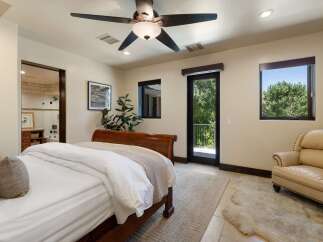 Experience luxurious living in this master suite, featuring a plush king-sized bed and direct access to a private balcony with stunning views.