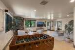 Experience ultimate relaxation and entertainment in this spacious living area, featuring a cozy fireplace and a large foosball table perfect for friendly competition.
