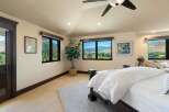 Experience breathtaking mountain views from this stunning bedroom, featuring expansive windows that bring the outdoors in.