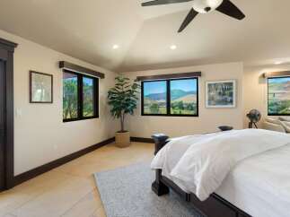 Experience breathtaking mountain views from this stunning bedroom, featuring expansive windows that bring the outdoors in.