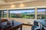 Experience breathtaking panoramic views from this stunning office space, featuring expansive windows that showcase rolling hills and majestic mountains.