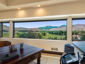 Experience breathtaking panoramic views from this stunning office space, featuring expansive windows that showcase rolling hills and majestic mountains.