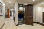 Discover a unique home with a playful twist, featuring a hidden tunnel entrance built into a stone-clad alcove.