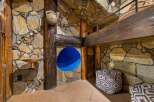 Discover a unique architectural gem featuring rustic stone walls and exposed wooden beams, creating a warm and inviting atmosphere.