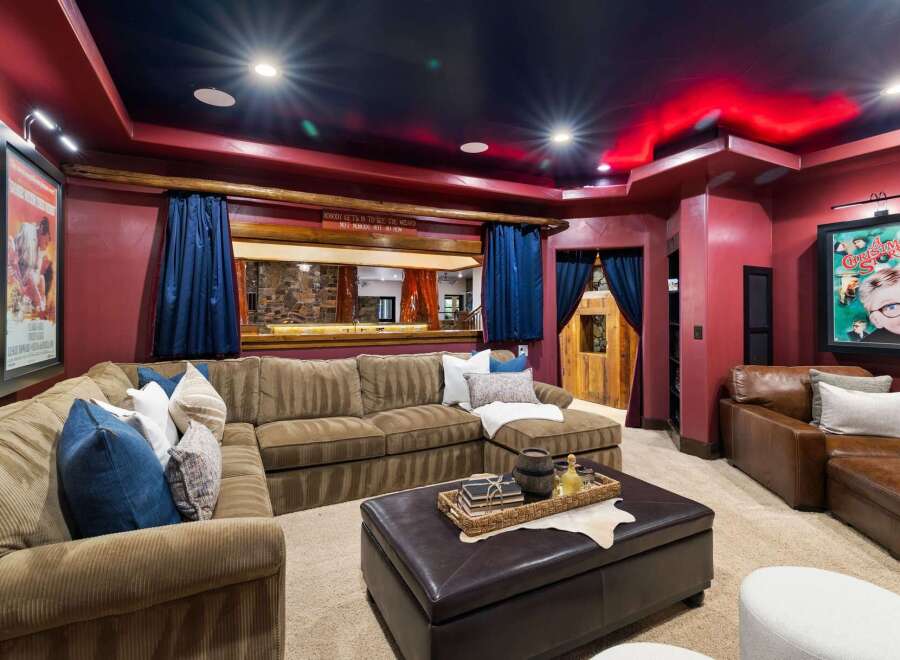 Step into a cinematic paradise with this custom home theater, featuring plush seating and immersive ambiance.