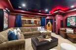 Step into a cinematic paradise with this custom home theater, featuring plush seating and immersive ambiance.