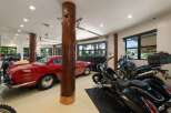 This spacious garage offers ample storage for multiple vehicles, including classic cars and motorcycles.