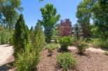 Discover a beautifully landscaped property featuring a variety of lush greenery and mature trees, creating a serene and private atmosphere.