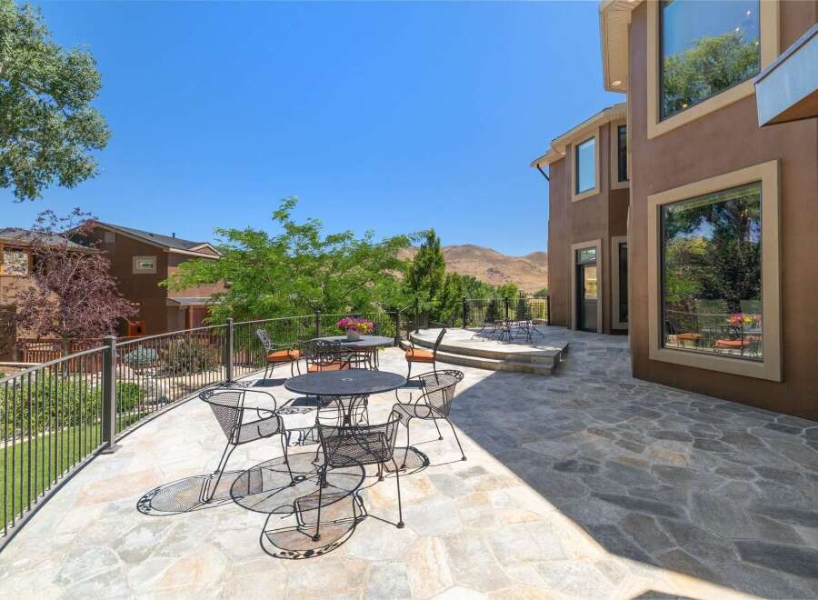 Enjoy outdoor living with this expansive stone patio, perfect for entertaining guests or relaxing with a view.