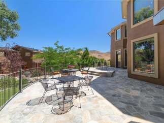 Enjoy outdoor living with this expansive stone patio, perfect for entertaining guests or relaxing with a view.