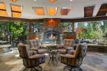 Experience ultimate outdoor living with this stunning patio featuring a grand stone fireplace, perfect for cozy evenings.
