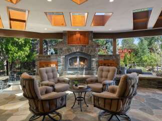Experience ultimate outdoor living with this stunning patio featuring a grand stone fireplace, perfect for cozy evenings.