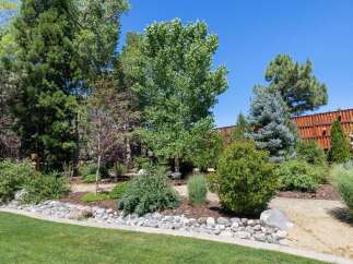 Discover a beautifully landscaped backyard oasis, perfect for outdoor living and entertaining.
