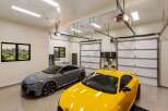 This spacious garage features two sleek Audi TT RS sports cars, one in a sophisticated grey and the other in a vibrant yellow.