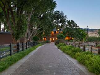 Welcome to this charming property, featuring a long brick pathway leading to a warm, inviting home.