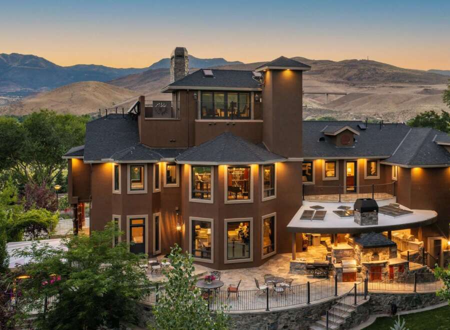 Experience luxury living in this stunning multi-level home, boasting breathtaking mountain views and an expansive outdoor entertainment area.