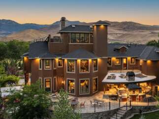 Experience luxury living in this stunning multi-level home, boasting breathtaking mountain views and an expansive outdoor entertainment area.