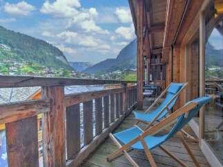 Experience breathtaking mountain views from this charming wooden balcony, perfect for enjoying your morning coffee or evening relaxation.