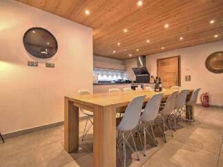 Experience elegant dining in this spacious room, featuring a large wooden table perfect for gatherings.