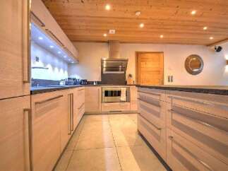 Experience modern living in this stunning kitchen featuring sleek, light wood cabinetry and a spacious island perfect for meal prep and entertaining.