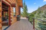 Experience rustic charm and modern comfort on this expansive log cabin deck, perfect for outdoor entertaining.