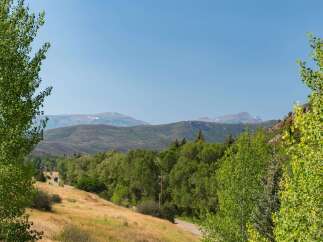Experience the serene beauty of this mountain landscape, perfect for a secluded getaway or a peaceful residence.