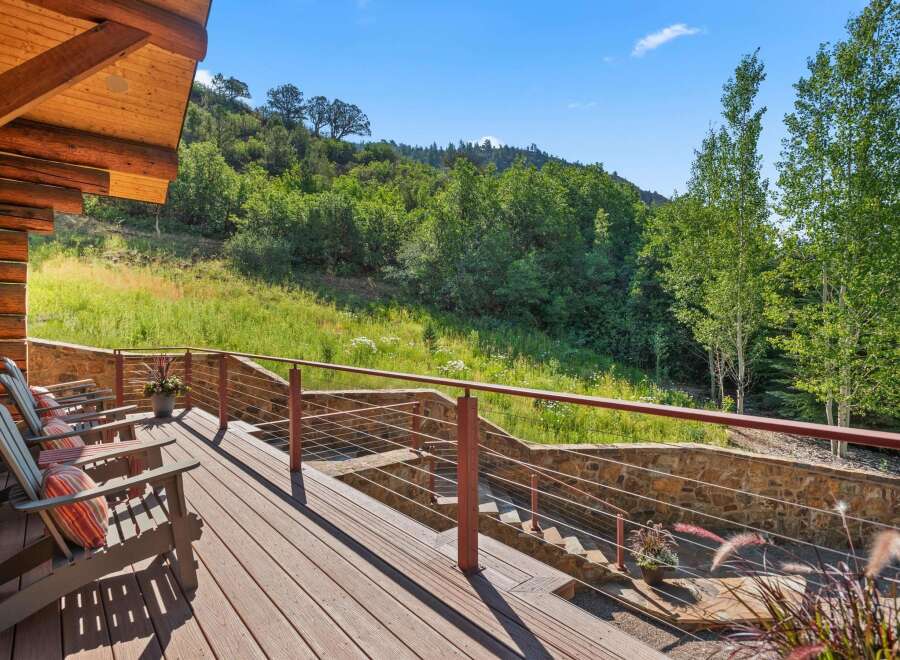 Enjoy breathtaking mountain views from this expansive wooden deck, perfect for outdoor entertaining or quiet relaxation.