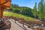 Enjoy breathtaking mountain views from this expansive wooden deck, perfect for outdoor entertaining or quiet relaxation.