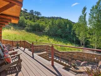 Enjoy breathtaking mountain views from this expansive wooden deck, perfect for outdoor entertaining or quiet relaxation.