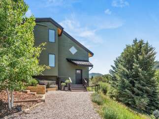 Nestled amidst lush greenery and rolling hills, this charming home offers a serene retreat.