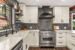 Experience culinary excellence in this stunning kitchen, featuring a professional-grade stainless steel range and a sleek, modern backsplash.