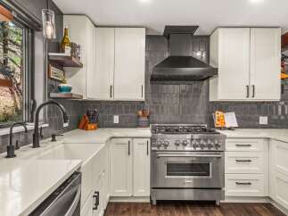 Experience culinary excellence in this stunning kitchen, featuring a professional-grade stainless steel range and a sleek, modern backsplash.