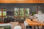 Experience breathtaking mountain views from this stunning living and dining area, featuring a large picture window that frames the lush greenery.