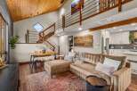 Experience modern mountain living in this stunning home featuring a vaulted wood-paneled ceiling and a dramatic open-concept living space.