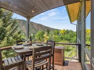 Enjoy breathtaking mountain views from this stunning deck, perfect for al fresco dining or relaxing with a glass of wine.