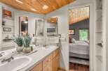 Experience modern comfort in this beautifully appointed bathroom featuring a dual vanity with ample counter space and elegant wood cabinetry.
