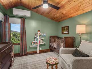 This charming nursery features a rustic wooden crib and a matching changing table, perfect for a cozy and inviting space.