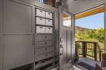 Step into this welcoming entryway featuring a custom built-in storage unit with ample shelving and drawers, perfect for organizing shoes and accessories.