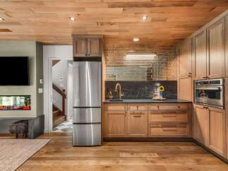 Experience modern living with this stunning kitchen featuring sleek stainless steel appliances, including a refrigerator and built-in oven.